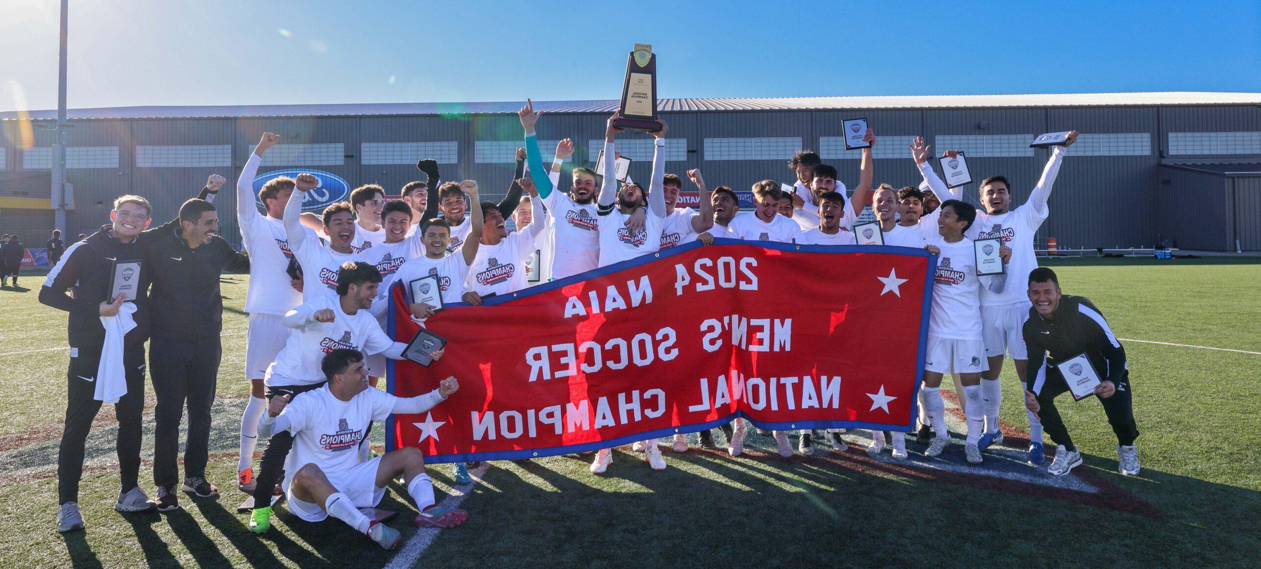 Dalton Men's Soccer Team posing with 2024 NAIA Men's Soccer National Champion Banner